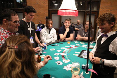 Group playing poker at a table.